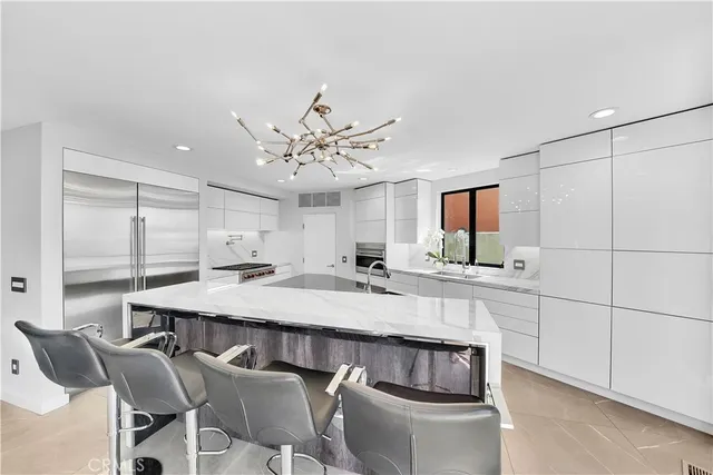 a large white kitchen with a table and chairs