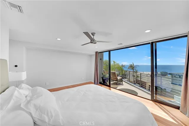 a bedroom with a bed and glass walk in closet