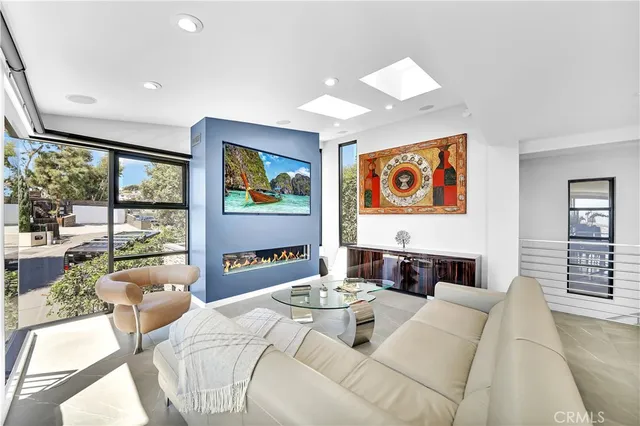 a living room with furniture and large windows