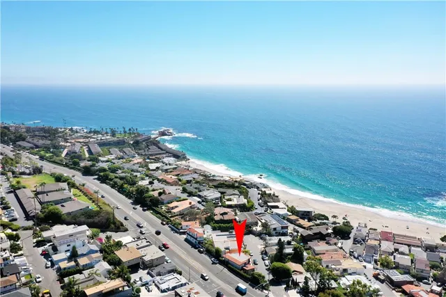 an aerial view of residential house with an outdoor space and seating
