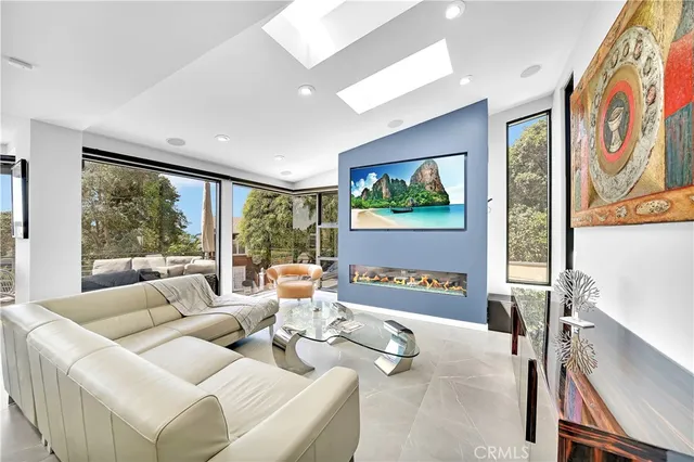 a living room with furniture tv and large window