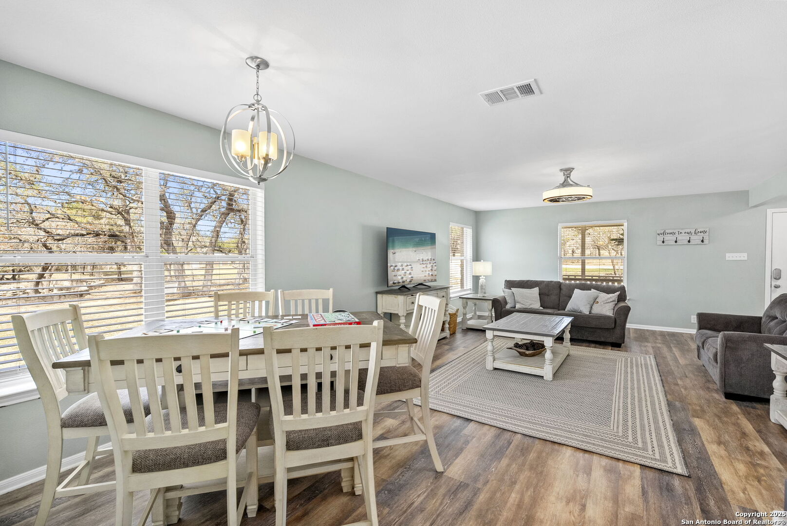 668 Indian Mound Road Tarpley, TX 78883 - Photo 16 of 50 a view of a dining room with furniture wooden floor and chandelier