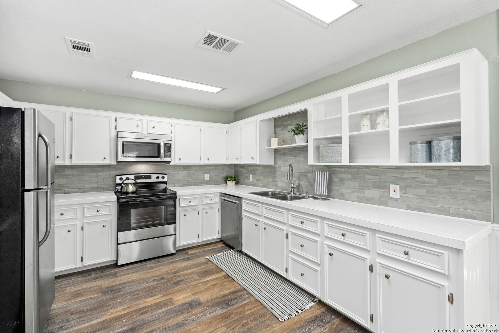 668 Indian Mound Road Tarpley, TX 78883 - Photo 25 of 50 a kitchen with stainless steel appliances granite countertop a stove sink and cabinets