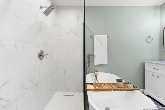 a en suite bathroom with a granite countertop sink and a mirror