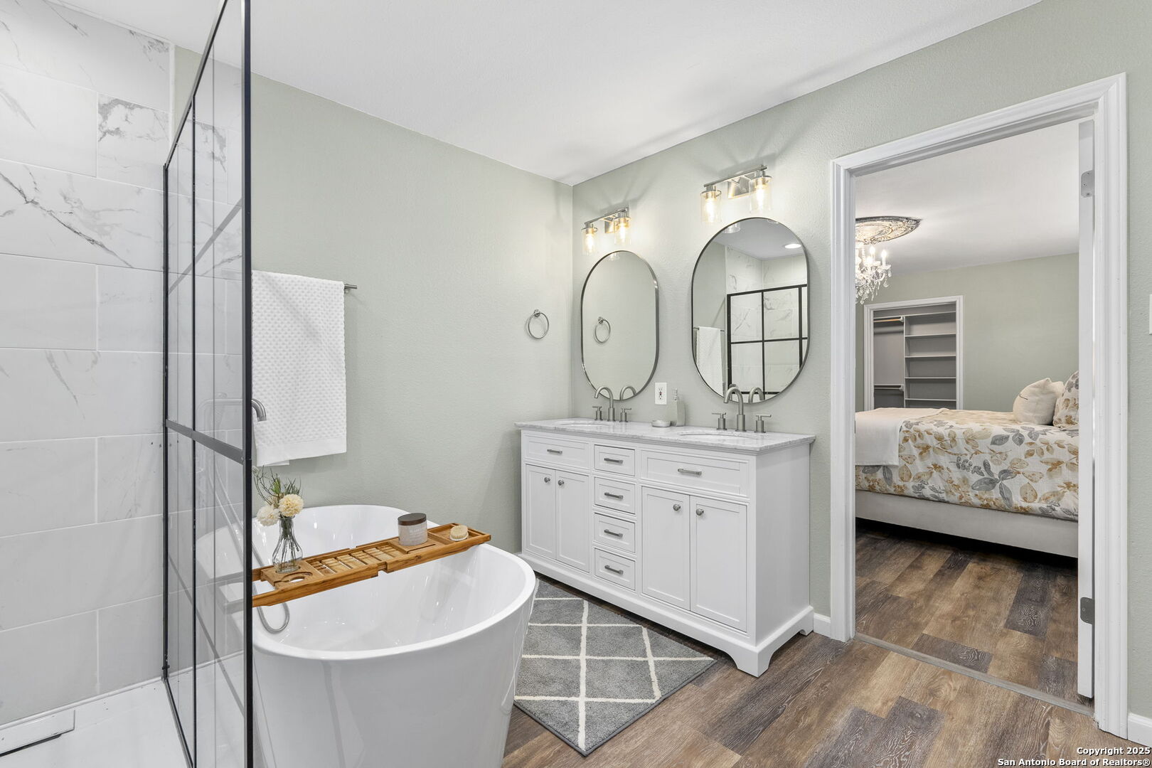 668 Indian Mound Road Tarpley, TX 78883 - Photo 34 of 50 a en suite bathroom with a granite countertop sink and a mirror