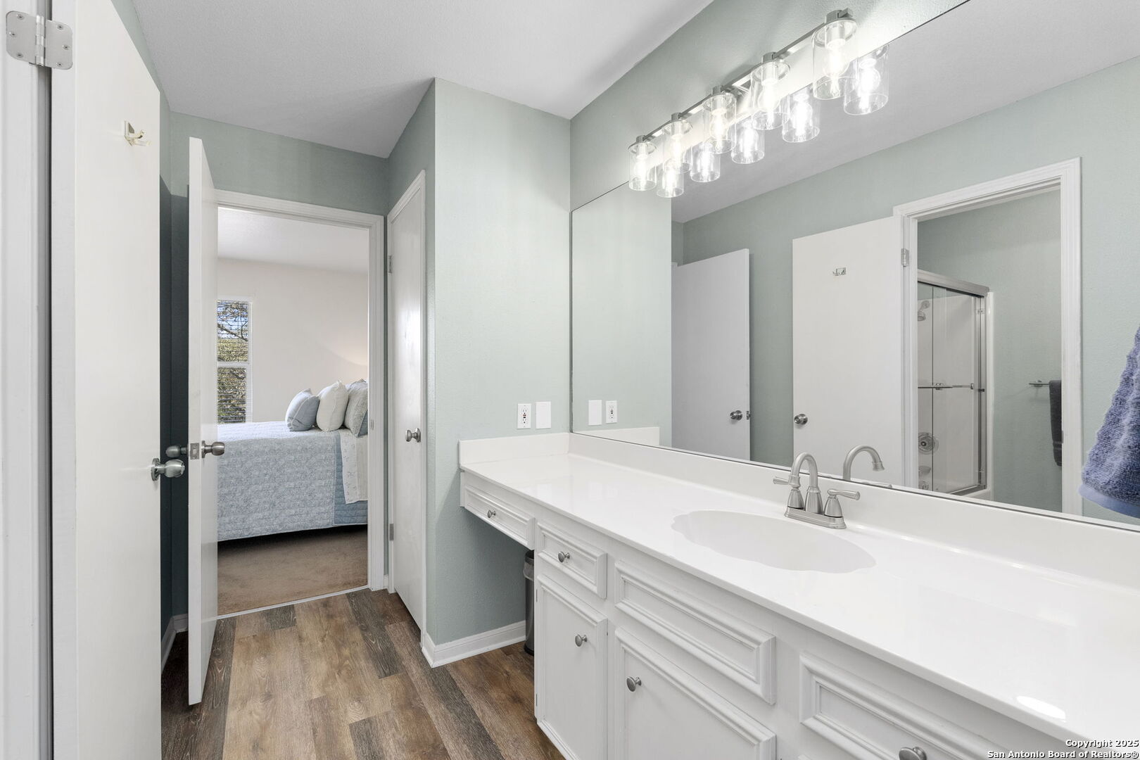 668 Indian Mound Road Tarpley, TX 78883 - Photo 38 of 50 a en suite bathroom with a double vanity sink and a mirror