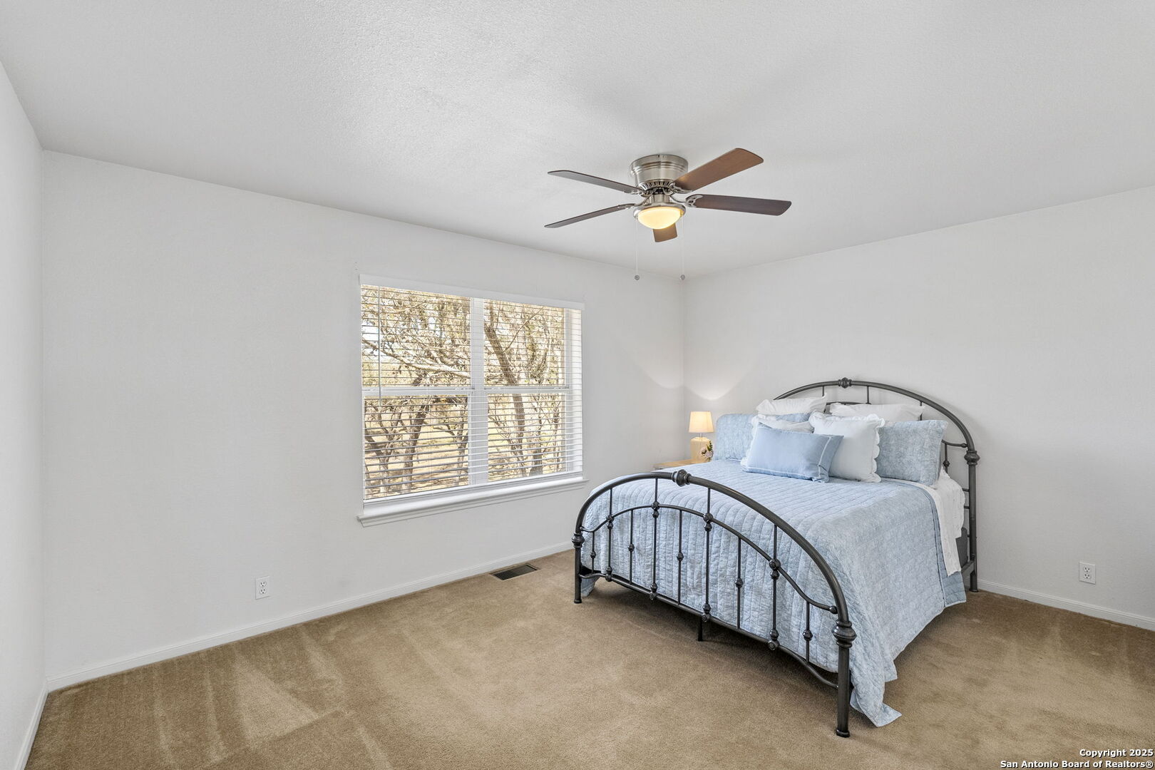 668 Indian Mound Road Tarpley, TX 78883 - Photo 40 of 50 a bedroom with a bed chandelier and a window