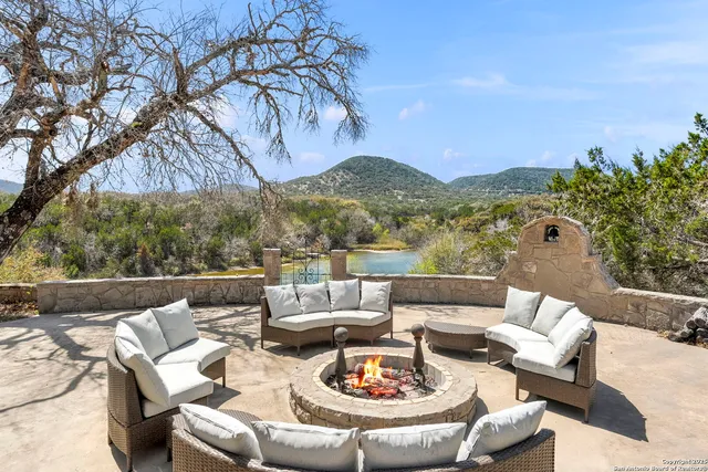 a view of a patio with couches potted plants and outdoor seating