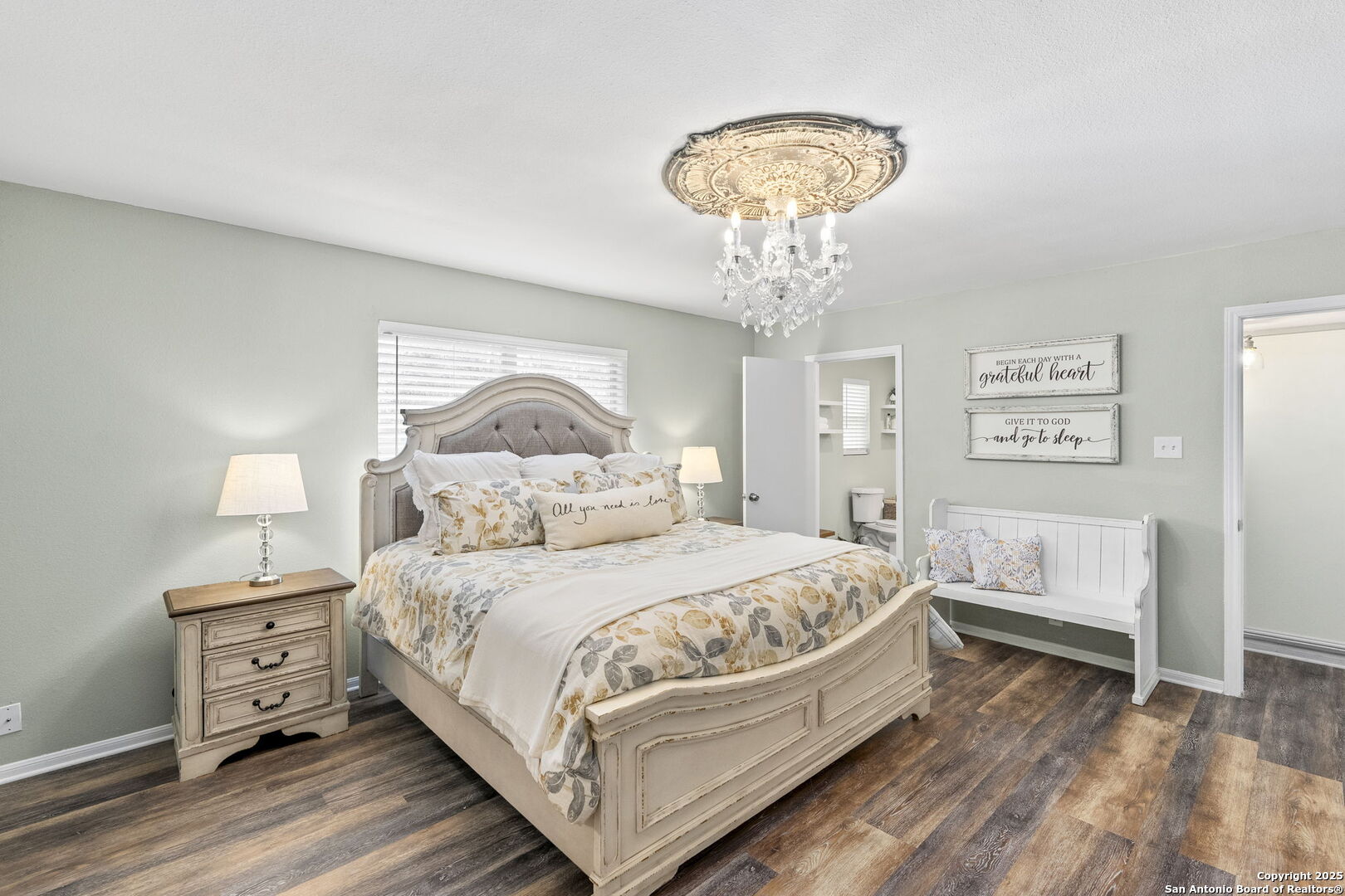 668 Indian Mound Road Tarpley, TX 78883 - Photo 8 of 50 a bedroom with a bed and a chandelier