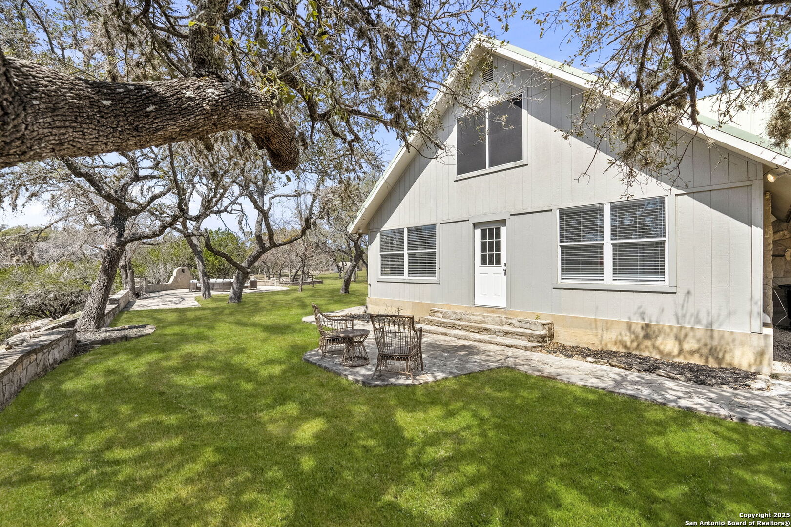 668 Indian Mound Road Tarpley, TX 78883 - Photo 10 of 50 a backyard of a house with table and chairs