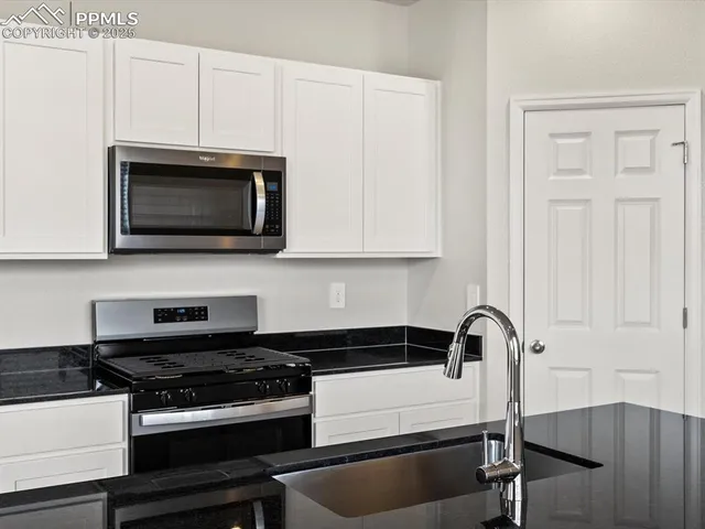 a kitchen with stainless steel appliances a stove a microwave and cabinets