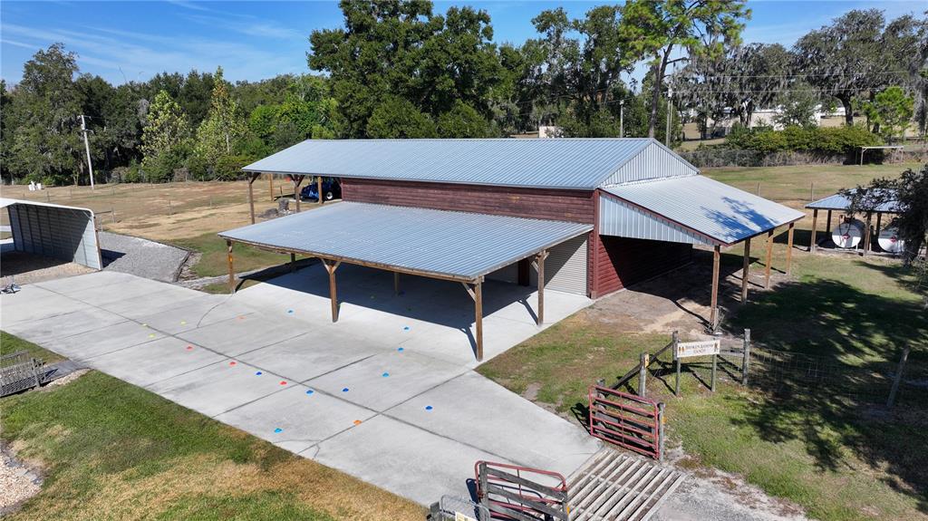 3182 Indian Ridge Place Lakeland, FL 33810 - Photo 14 of 45 a view of a patio with table and chairs a barbeque with wooden floor and fence