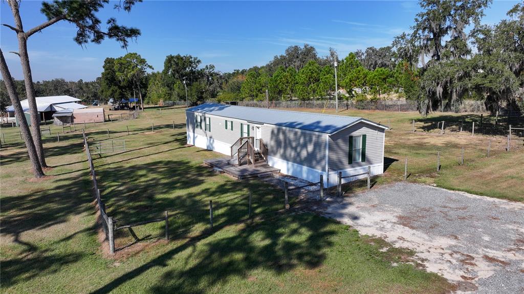 3182 Indian Ridge Place Lakeland, FL 33810 - Photo 16 of 45 a view of a house with backyard and sitting area
