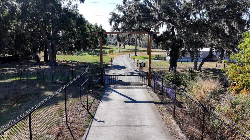 3182 Indian Ridge Place Lakeland, FL 33810 - Photo 18 of 45 a view of a swimming pool with a patio and a yard