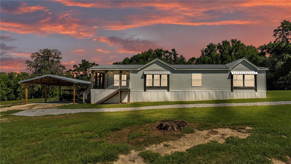 3182 Indian Ridge Place Lakeland, FL 33810 - Photo 26 of 45 a view of a house with a swimming pool and a yard
