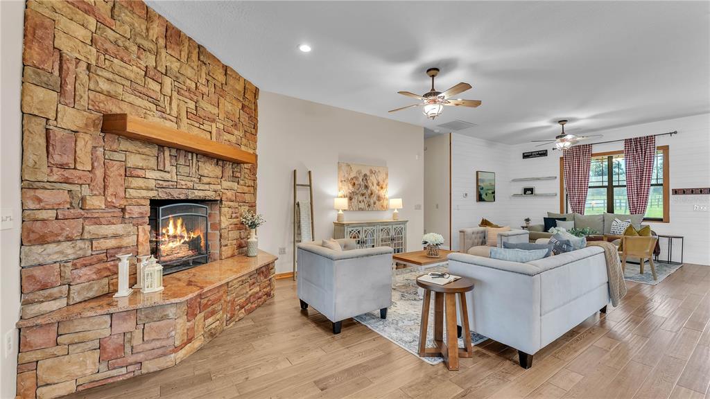 3182 Indian Ridge Place Lakeland, FL 33810 - Photo 32 of 45 a living room with fireplace furniture and a fireplace