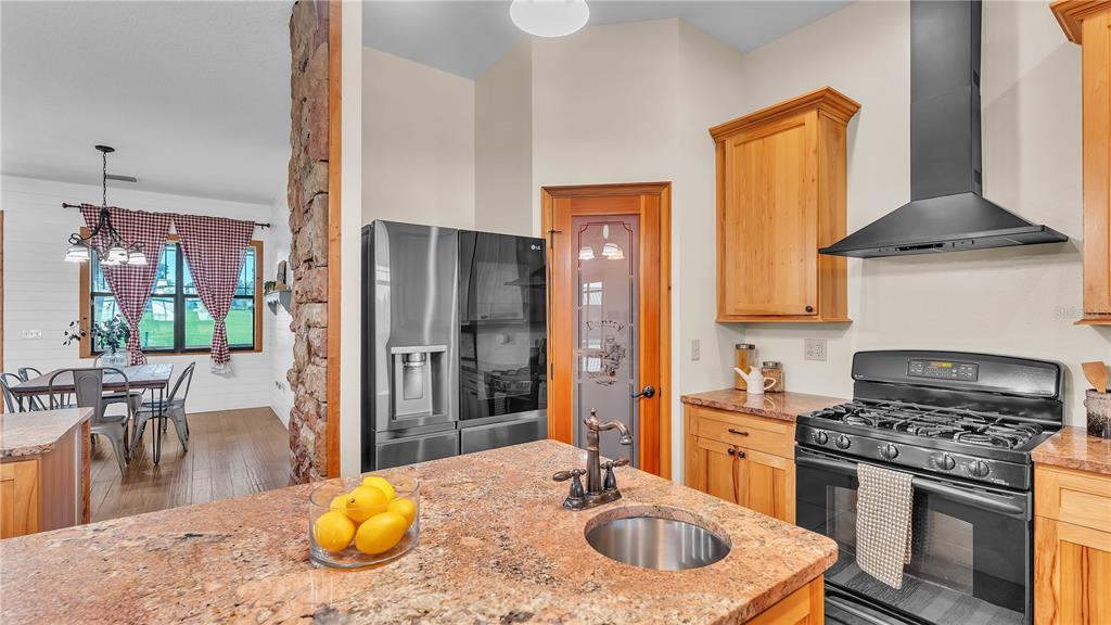 3182 Indian Ridge Place Lakeland, FL 33810 - Photo 34 of 45 a kitchen with a stove a sink and a refrigerator