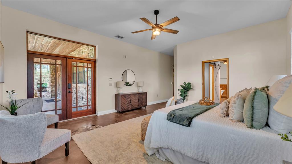 3182 Indian Ridge Place Lakeland, FL 33810 - Photo 36 of 45 a bedroom with a large bed and a chandelier