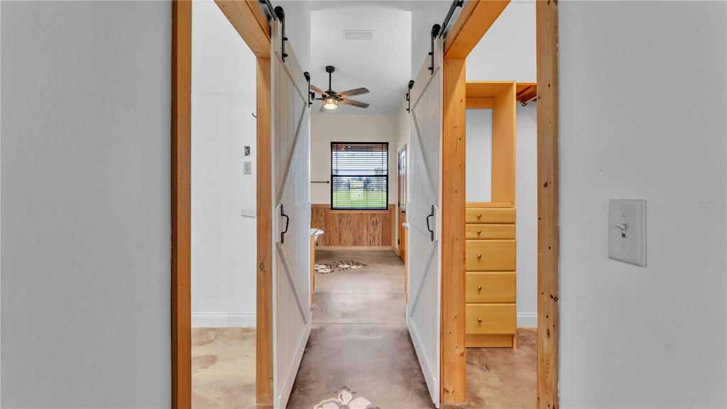 3182 Indian Ridge Place Lakeland, FL 33810 - Photo 37 of 45 hallway with wooden floor and glass door