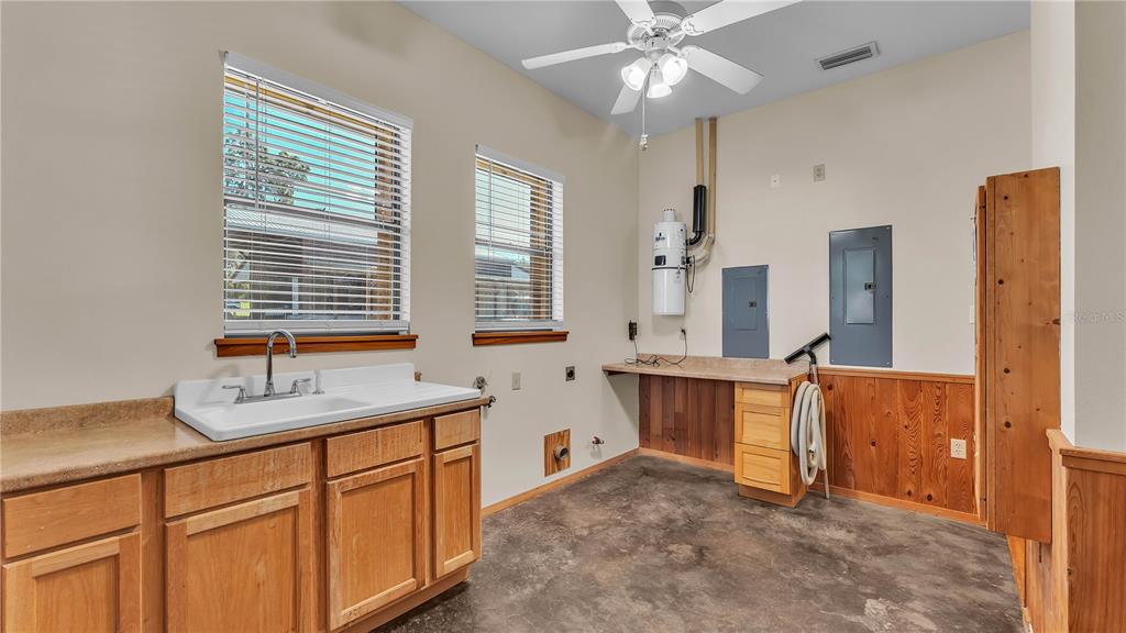 3182 Indian Ridge Place Lakeland, FL 33810 - Photo 40 of 45 a kitchen with stainless steel appliances granite countertop a sink cabinets and window