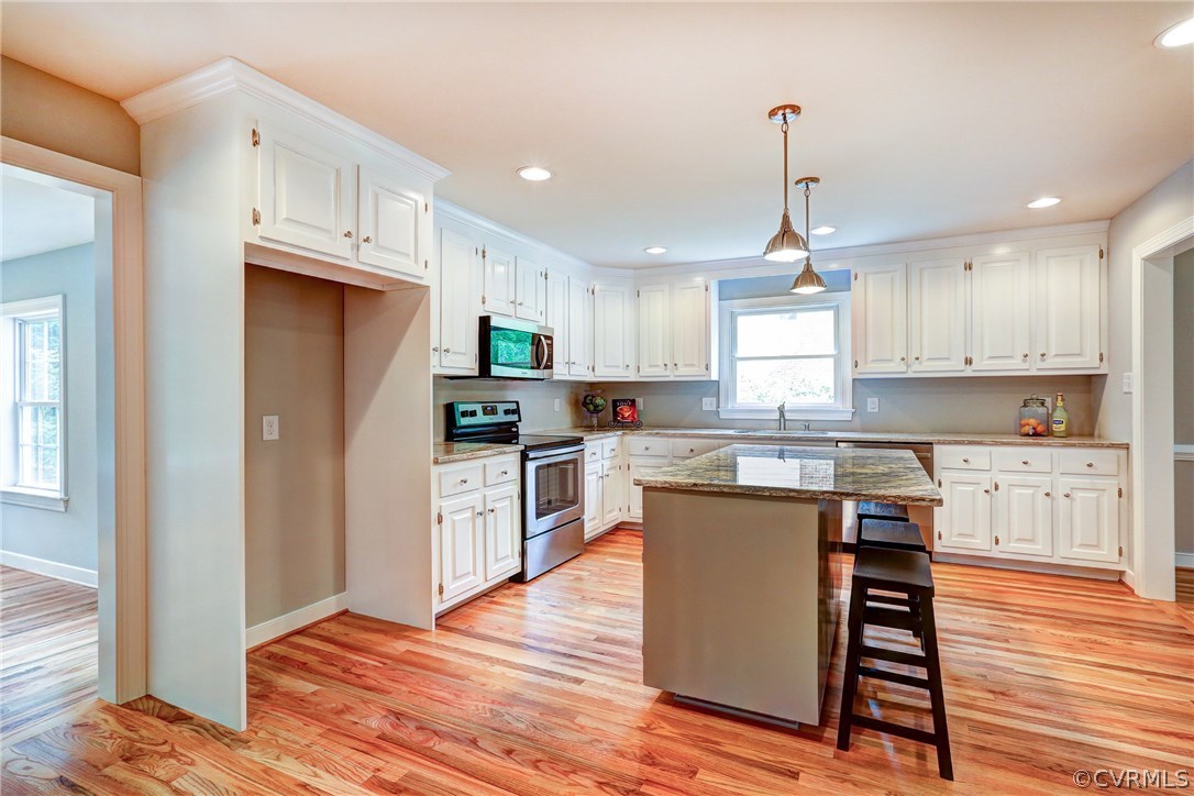 13231 Drakewood Road Midlothian, VA 23113 - Photo 10 of 31 a kitchen with stainless steel appliances granite countertop a refrigerator a sink dishwasher a stove and white countertops with wooden floor
