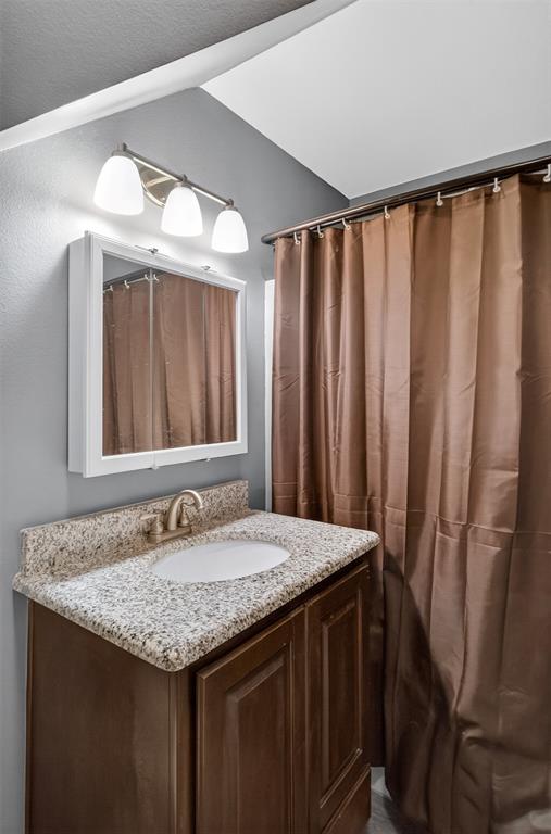 720 Haggerty Road Karnack, TX 75661 - Photo 25 of 39 a bathroom with a granite countertop sink and a mirror