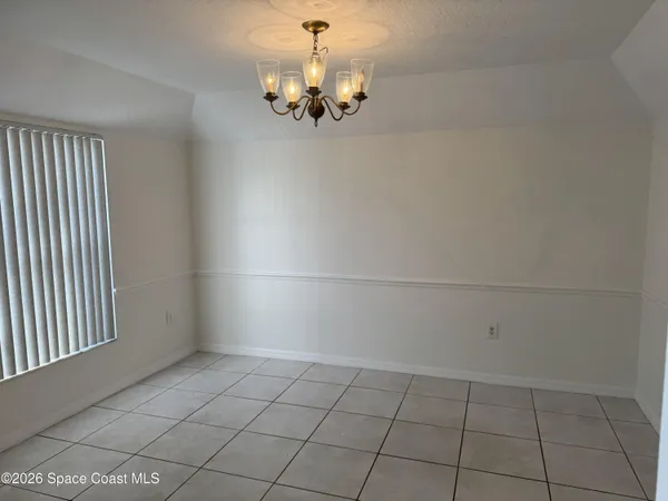 a view of a room with an empty space and a window