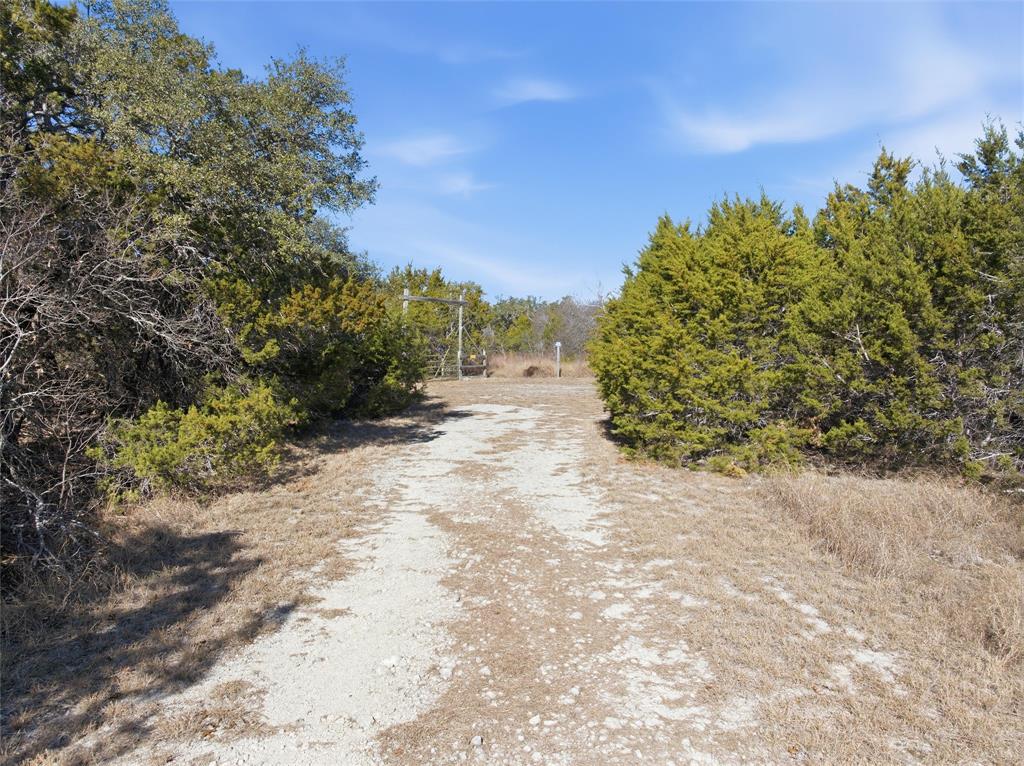 2 Whitney Street Morgan, TX 76671 - Photo 2 of 13 a view of a dirt road with trees in the background