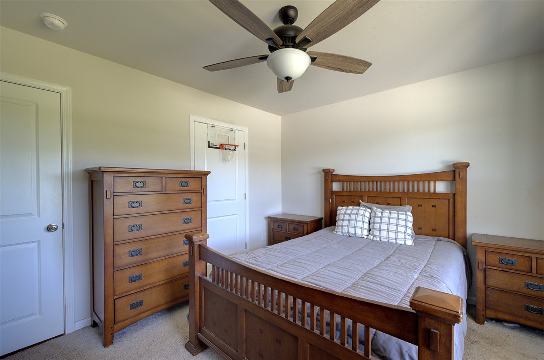 408 Chadwick Lane Walhalla, SC 29691 - Photo 19 of 44 Comfortable, naturally illuminated bedroom featuring a classic wooden bed frame and a practical ceiling fan for optimal air circulation.