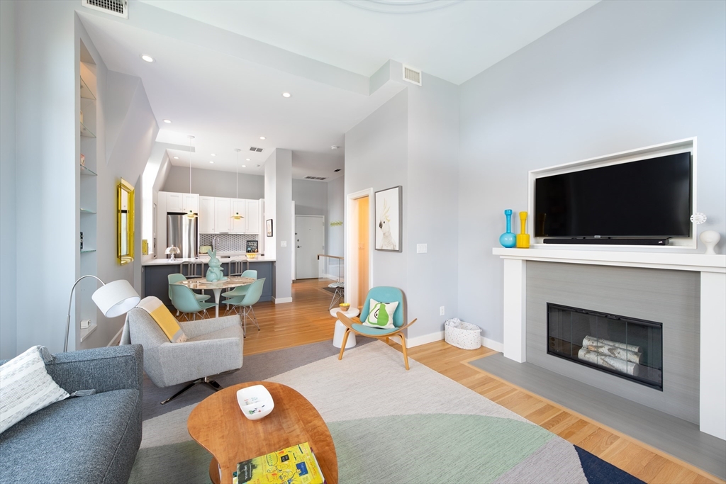 130 Appleton Street, Unit 4D Boston, MA 02116 - Photo 12 of 34 a living room with furniture a flat screen tv and a fireplace