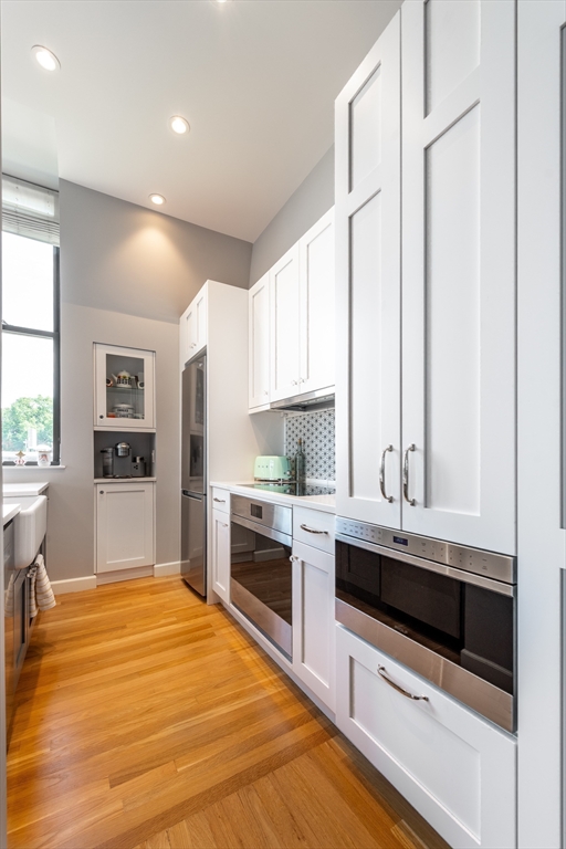 130 Appleton Street, Unit 4D Boston, MA 02116 - Photo 15 of 34 a large kitchen with kitchen island a sink stainless steel appliances and cabinets