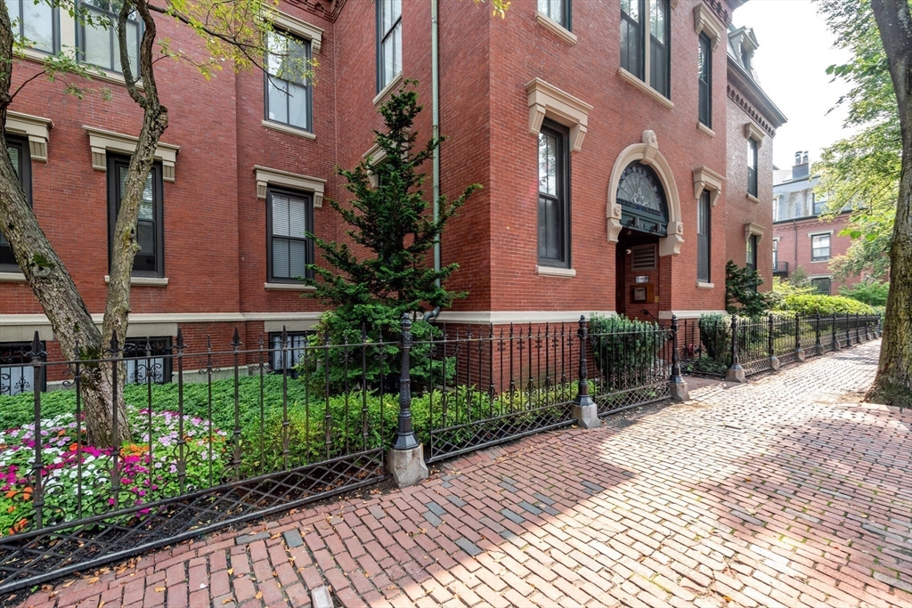 130 Appleton Street, Unit 4D Boston, MA 02116 - Photo 3 of 34 a view of a brick house with plants and large tree