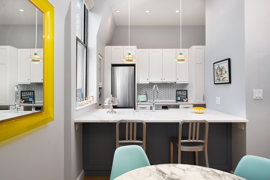 130 Appleton Street, Unit 4D Boston, MA 02116 - Photo 8 of 34 a kitchen with stainless steel appliances a sink stove and refrigerator