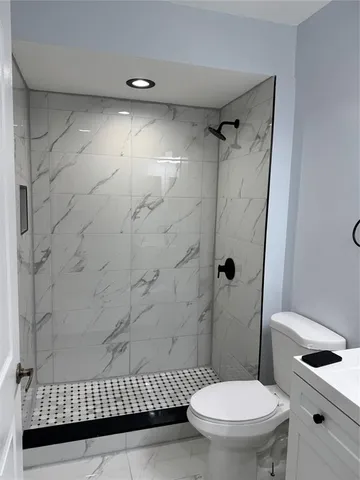 a bathroom with a toilet and a shower