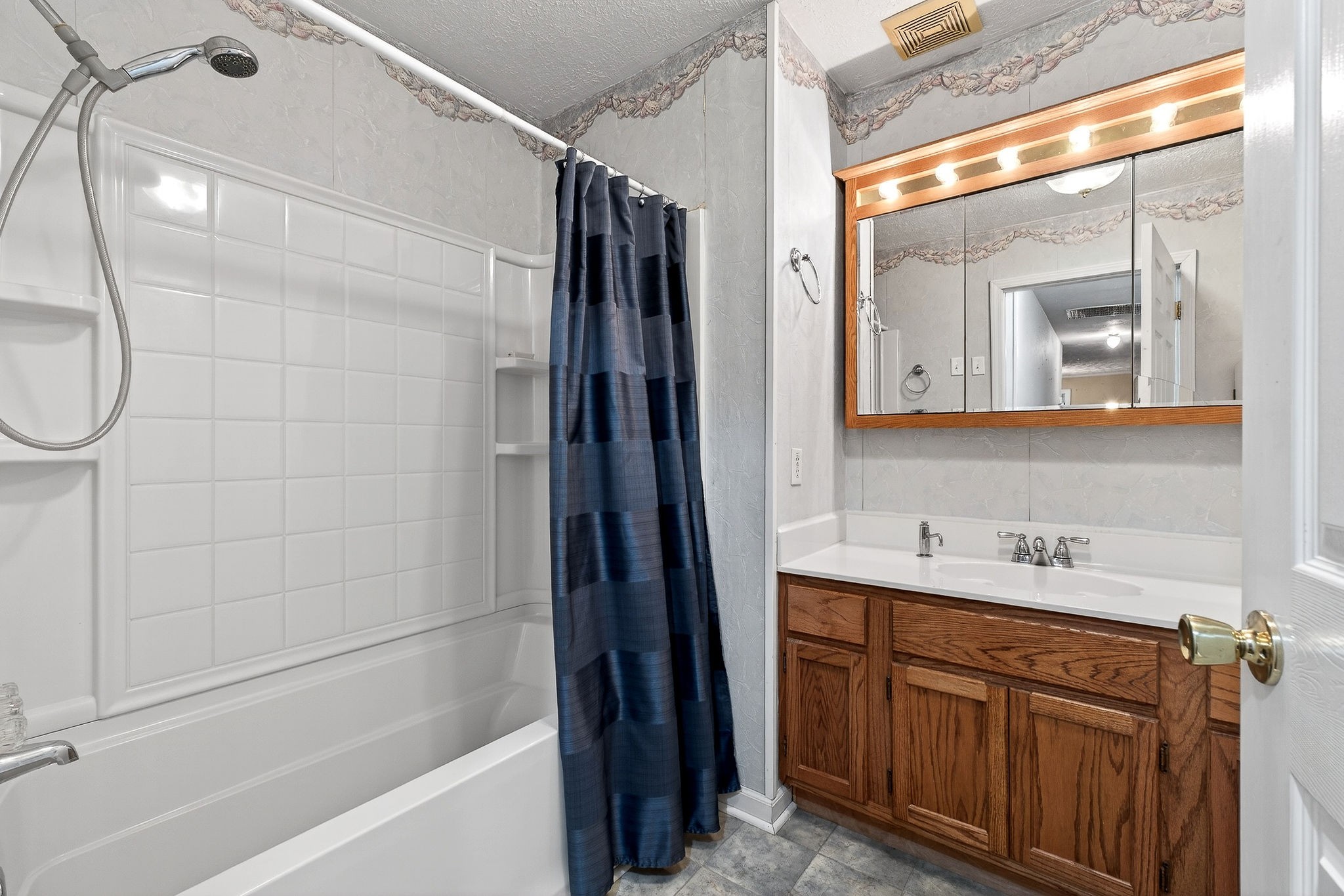 850 Wesley Chapel Road Sparta, TN 38583 - Photo 15 of 68 a bathroom with a double vanity sink a mirror and a bathtub