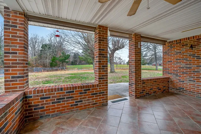 a kitchen with granite countertop wooden floors stainless steel appliances a sink