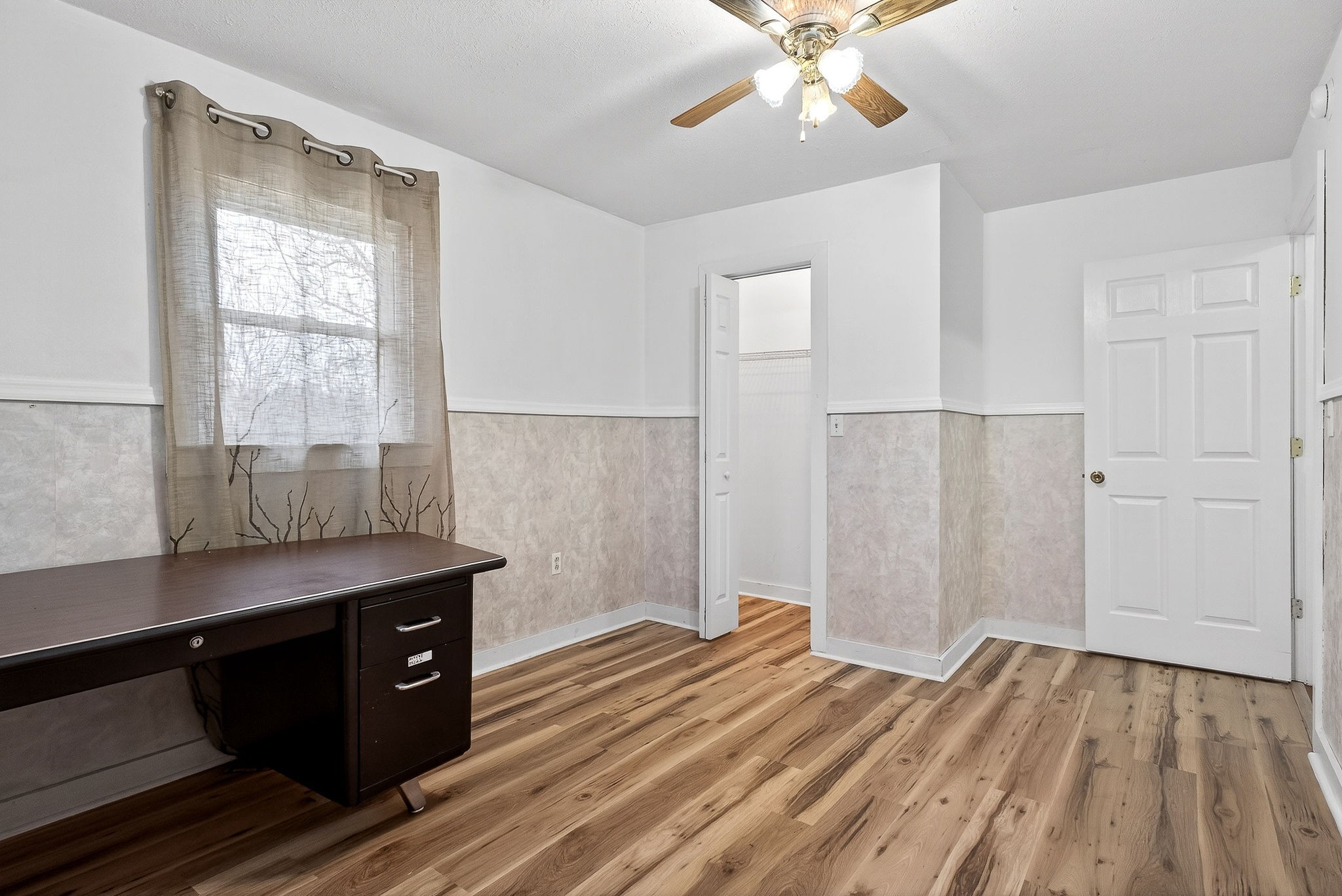 850 Wesley Chapel Road Sparta, TN 38583 - Photo 35 of 68 a room with a desk and wooden floor