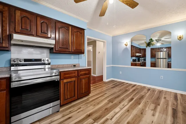 a view of a dining room with furniture and wooden floor