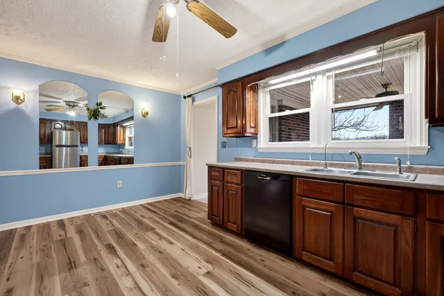 an empty room with closet and a chandelier fan