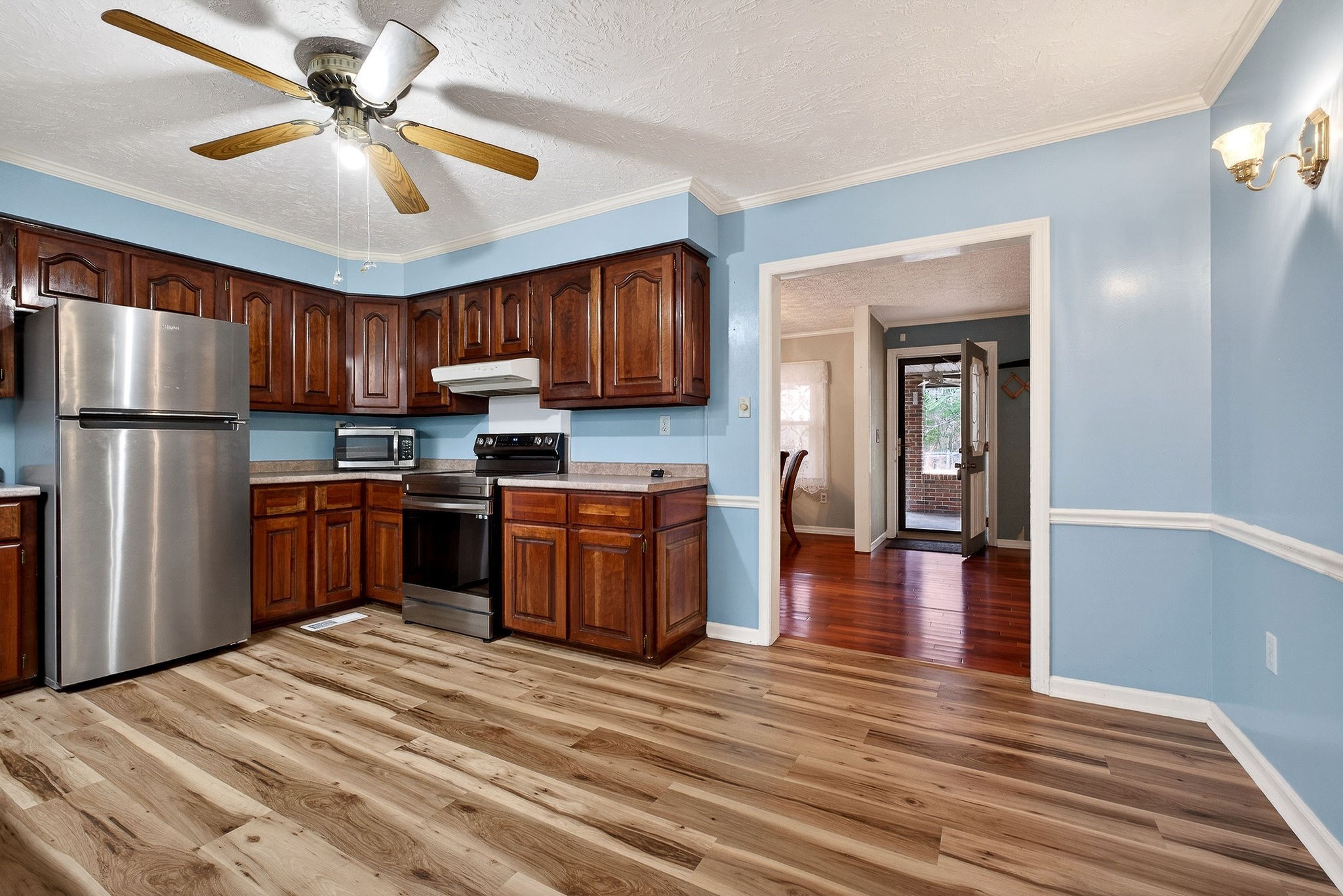 850 Wesley Chapel Road Sparta, TN 38583 - Photo 5 of 68 a kitchen with granite countertop wooden floors stainless steel appliances a sink