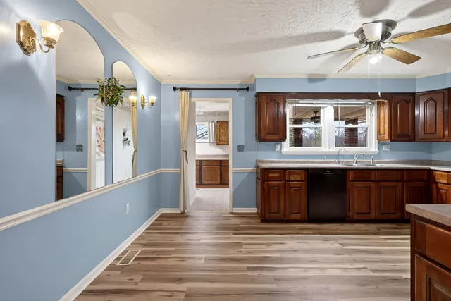 a view of a dining room with furniture a chandelier and wooden floor