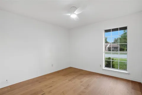 an empty room with windows and entrance