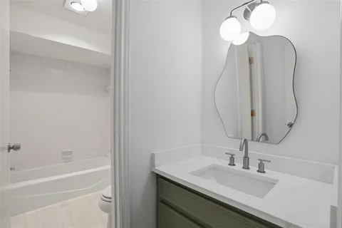 a bathroom with a sink vanity and a mirror