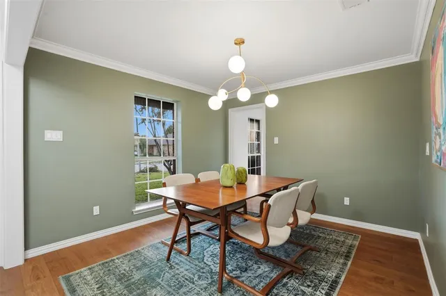 a view of a dining room with a table and chairs