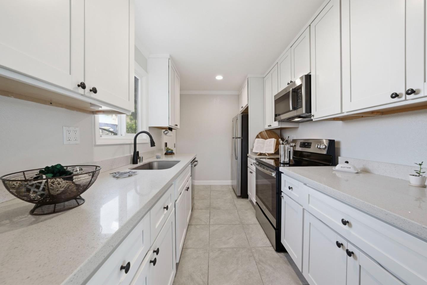 2793 Ruff Court Pinole, CA 94564 - Photo 16 of 53 a kitchen with stainless steel appliances granite countertop a sink a stove and a microwave