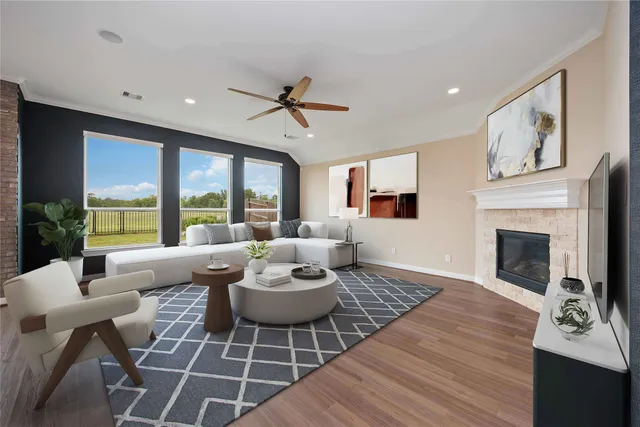 a living room with furniture a fireplace and a floor to ceiling window