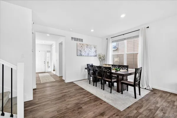 a view of a dining room with furniture and wooden floor