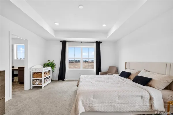 a bed room with a bed and a chair