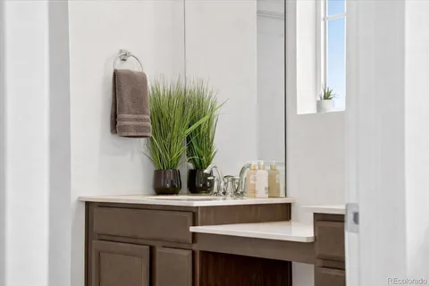 a bathroom with a granite countertop sink a toilet and shower
