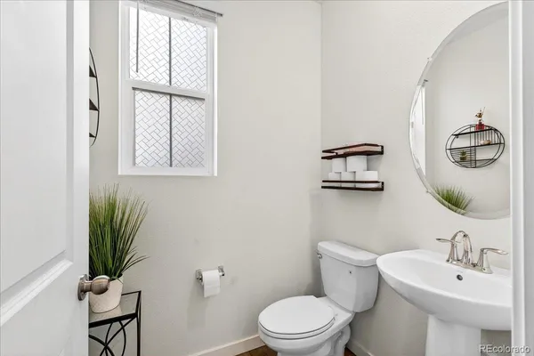 a bathroom with a toilet a sink and a window